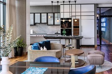 Boston apartment for rent - A modern living room with a glass table and blue cushions.