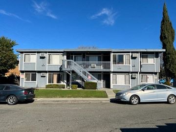 Fairfield apartment for rent - A grey apartment building with two cars parked in front.