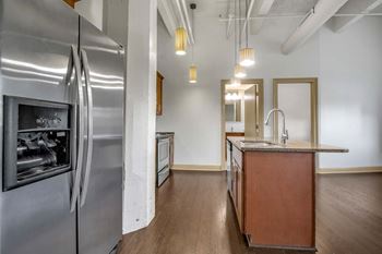 Galley kitchen with island and pendant lights