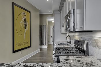Kitchen with gas range and gray cabinetry