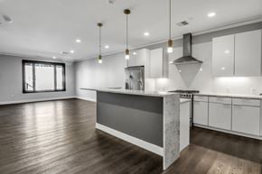 Buffalo apartment for rent - A modern kitchen with a large island and wooden floors.