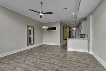 Open floor plan with gray walls and ceiling fan