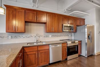 Kitchen with wood cabinets and tiled backsplash