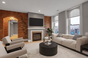 Buffalo apartment for rent - Living room with fireplace and exposed brick walls at The Granite Works Apartments, New York