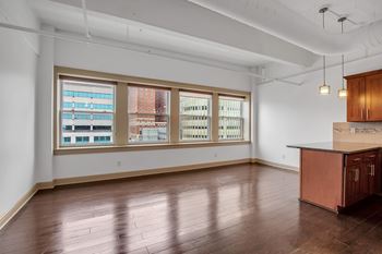 Open living space with hardwood floors and kitchen