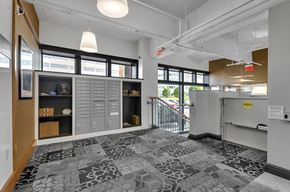 Buffalo apartment for rent - the lobby of a building with a reception desk and a door to a staircase at 100 South Apartments, Buffalo, NY