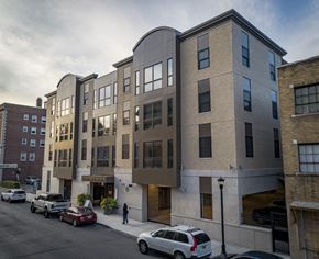 Buffalo apartment for rent - a new apartment building on a city street with cars at Nineteen North, Buffalo