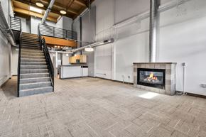 Buffalo apartment for rent - A large open space with a staircase, a fireplace, and a tiled floor.