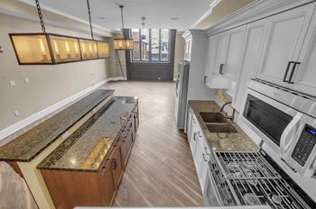 Spacious kitchen with center island and granite countertops