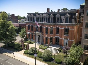 Historic brick building exterior with american flag