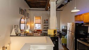 Pittsburgh apartment for rent - a kitchen with a counter top next to a living room