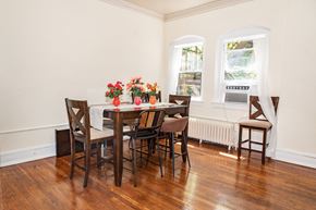 Pittsburgh apartment for rent - A dining room with a wooden table and chairs.