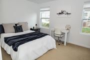 Pittsburgh townhouse for rent - A bedroom with a large bed and a desk. at Highland Village, Ross Township, Pittsburgh, PA 15229