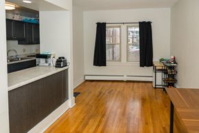 Pittsburgh apartment for rent - A kitchen with black cabinets and a wooden floor.