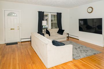 Pittsburgh apartment for rent - A living room with a white couch and a television.