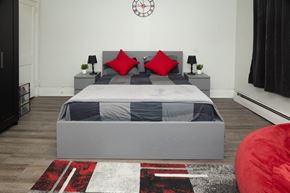 Pittsburgh apartment for rent - A bedroom with a large bed and a red bean bag chair.