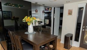 Pittsburgh apartment for rent - a dining room with a wooden table and chairs and a vase of flowers on the table