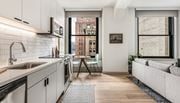 Pittsburgh apartment for rent - a kitchen with white cabinets and a sink and a window at The Commonwealth Building, Pittsburgh