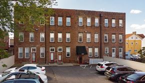 Pittsburgh apartment for rent - a large brick building with a parking lot in front of it
