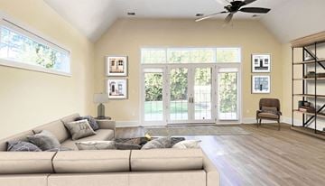 Pittsburgh apartment for rent - A living room with a beige couch and a ceiling fan.