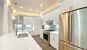 Pittsburgh apartment for rent - a kitchen with white cabinets and stainless steel appliances
