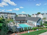 Pittsburgh townhouse for rent - A swimming pool is surrounded by a fence and bushes. at Highland Village, Ross Township, Pittsburgh, PA 15229