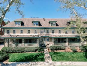 Pittsburgh apartment for rent - A large, two-story house with a green lawn in front.