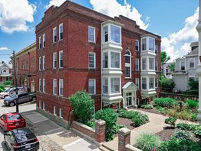 Pittsburgh apartment for rent - A red brick building with white trim and windows.