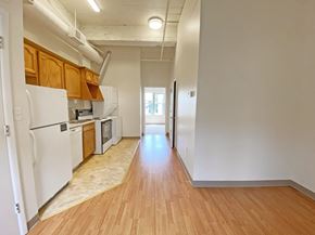 Pittsburgh apartment for rent - a kitchen with white appliances and wood flooring