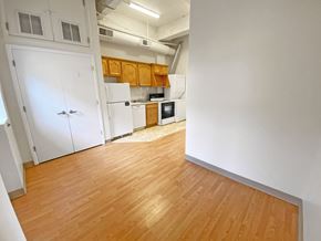 Pittsburgh apartment for rent - a kitchen with white appliances and wood flooring