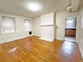 Pittsburgh apartment for rent - A room with wooden floors and white walls.