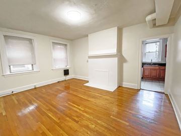 Pittsburgh apartment for rent - A room with wooden floors and white walls.