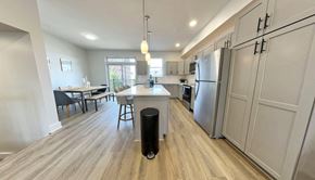 Pittsburgh apartment for rent - a kitchen and dining room with stainless steel appliances and wood flooring