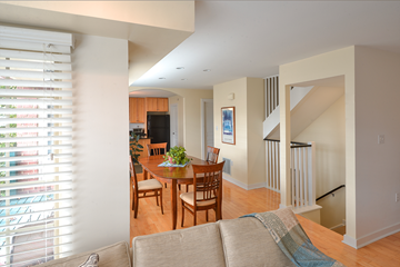 Pittsburgh townhouse for rent - A living room with a couch and a dining table.