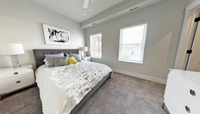 Pittsburgh apartment for rent - a bedroom with a bed and plants on the walls