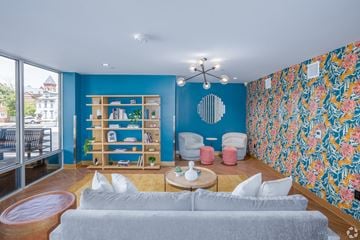 Pittsburgh apartment for rent - A living room with a grey couch and a blue wall.