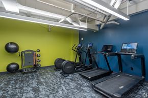 Pittsburgh apartment for rent - A gym with a treadmill, exercise bike, and other equipment.at The Jones Tower at the Collective, Pittsburgh, PA 15203