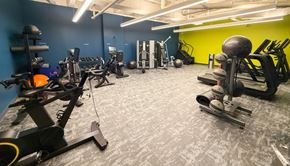 Pittsburgh apartment for rent - A gym with a variety of equipment including a rowing machine, a leg press machine, and a weight bench.at The Jones Tower at the Collective, Pittsburgh, PA 15203