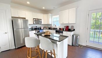 A kitchen with white cabinets