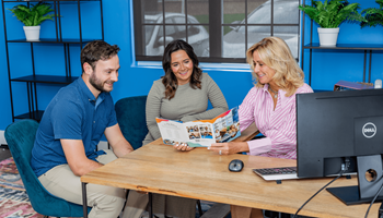 Three people are sitting at a table