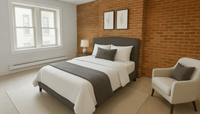 Pittsburgh apartment for rent - A bedroom with a large bed and a chair.