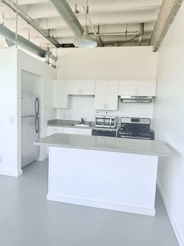 Oklahoma City apartment for rent - A kitchen with white cabinets and a countertop.