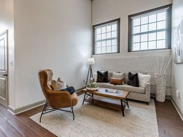 Oklahoma City apartment for rent - A living room with a brown chair and a white couch.