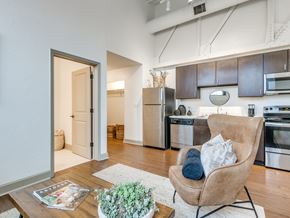 Oklahoma City apartment for rent - A modern kitchen with a chair and a plant on the table.