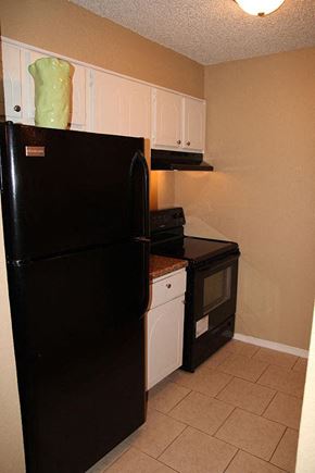 Oklahoma City apartment for rent - a kitchen with a black refrigerator and a stove