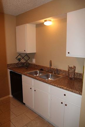 Oklahoma City apartment for rent - a kitchen with a sink and white cabinets
