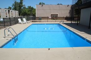 Oklahoma City apartment for rent - the pool at our apartments has a large blue pool and chairs