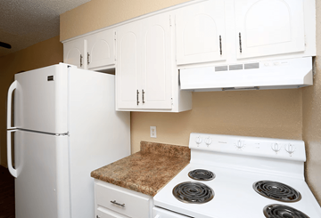Oklahoma City apartment for rent - A white refrigerator and stove in a kitchen.