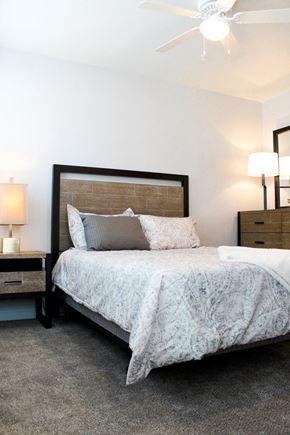 Oklahoma City apartment for rent - a bedroom with a bed and two night stands and a ceiling fan