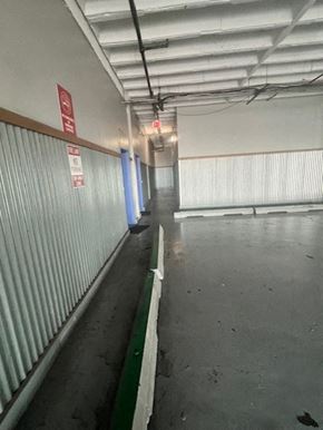 Oklahoma City apartment for rent - A long corridor with a red sign on the wall.